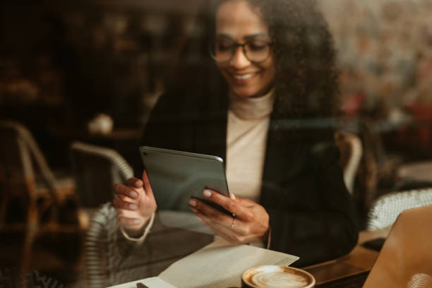 istock Businesswoman using digital tablet at cafe 1251138077