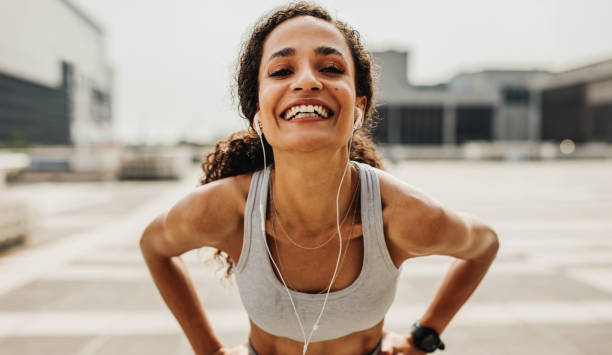 istock Cheerful female runner in the city 1251138115