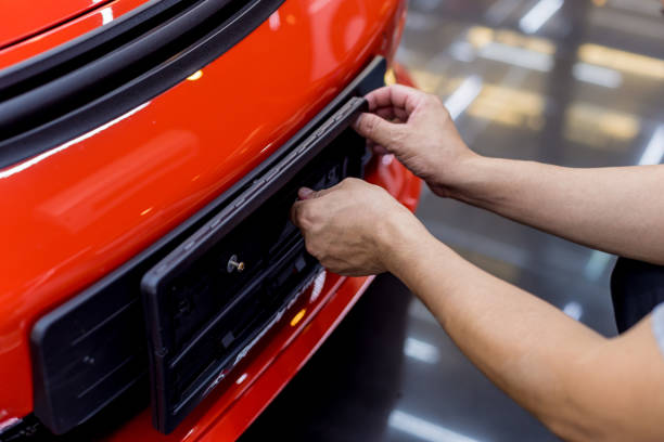 istock Technician changing car plate number in service center. 1251138857