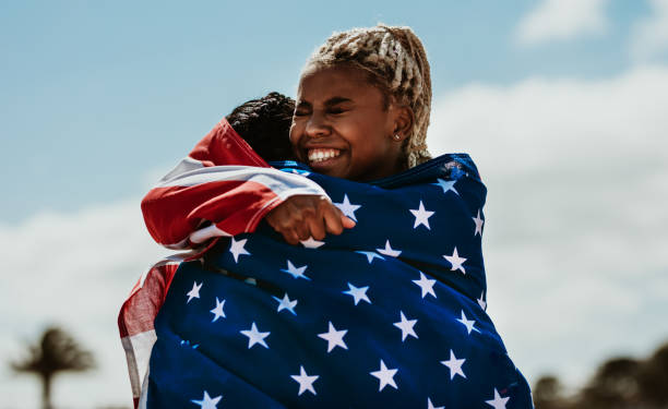 istock American female athletes with flag hugging each other after a win 1251139203
