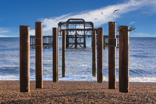 The West Pier in Brighton Sussex. The pier is in a state of disrepair having been neglected for years but still takes on a beauty all of its own when silhouetted against an evening sunset