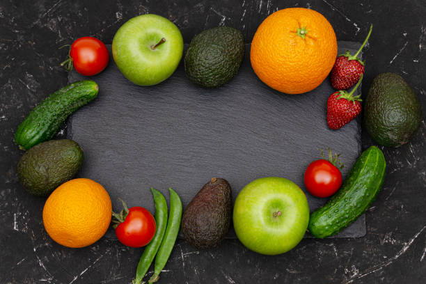 istock Assorted fruits and vegetables on a black textured background. Top view, copy space. 1251139280