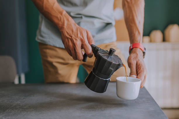 istock Hands of an Anonymous Man Pouring Himself Coffee at the Office 1251140969