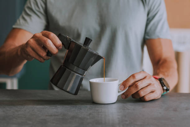 istock Hands of an Anonymous Man Pouring Himself Coffee at the Office 1251140980