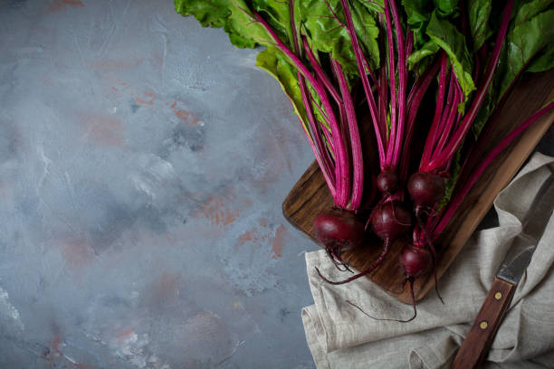 istock Fresh young organic beet on a gray concrete background. Selective focus. Top view. 1251141385