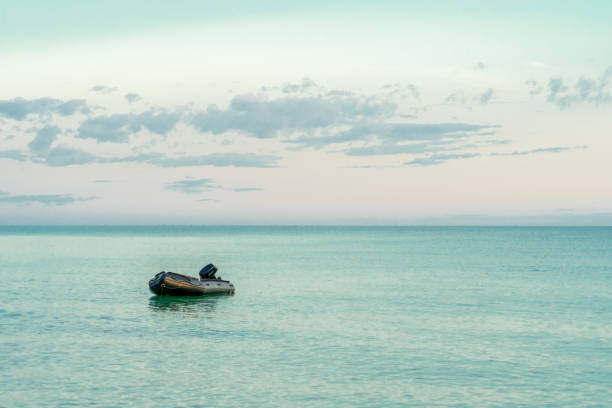 Lifeboat on peaceful sea with copy space with sunset time