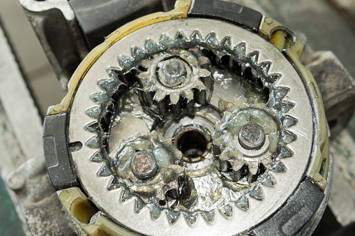 Lubricated planetary gearbox of a disassembled car starter in a car repair shop