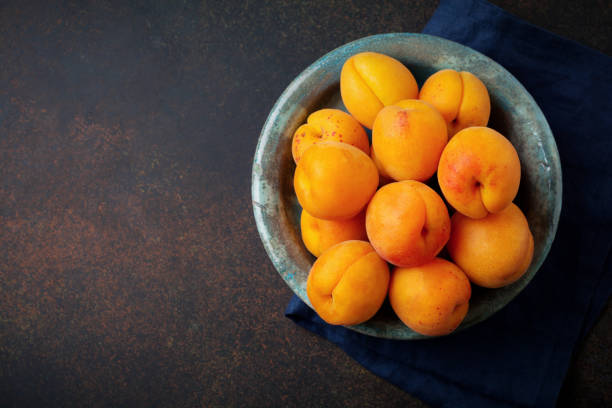istock Delicious ripe apricots on a dark background. Selective focus. Top view. copy space. 1251142290