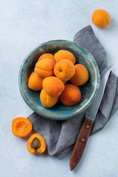 istock Delicious ripe apricots on a light concrete background. Selective focus. Top view. Copy space. 1251142302