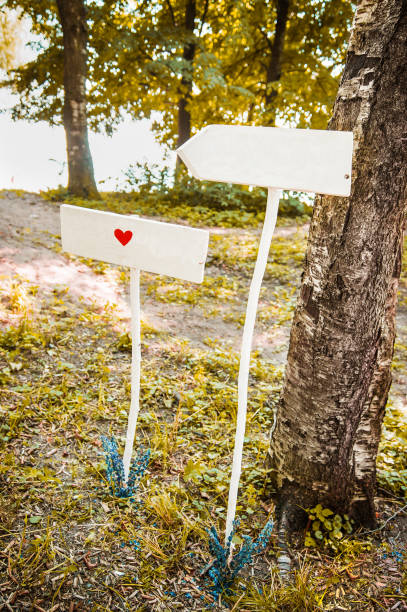 istock Two wooden white signs with a heart drawn on them. 1251143531