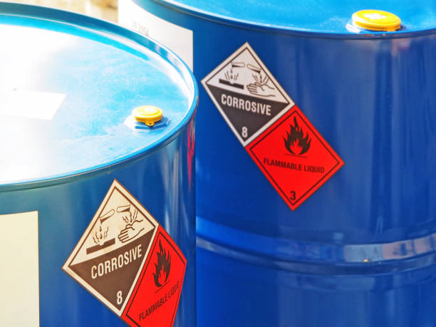 the close-up shot of blue color hazardous dangerous chemical barrels. the close-up shot of blue color hazardous dangerous chemical barrels ,have warning labels of corrosive & flammable liquid in daylight on daytime. gasoline photos stock pictures, royalty-free photos & images