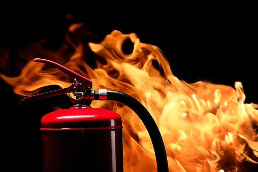 Red Fire Extinguisher on Yellow background