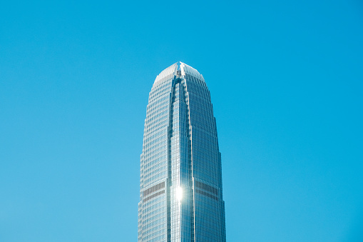 HongKong, China - November, 2019: Top of the two International Finance Centre skyscraper building in Central Hong Kong on clear blue sky