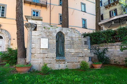 todi,italy june 20 2020 :monument to jacopone da todi placed at the foot of the cathedral of s fortrunato