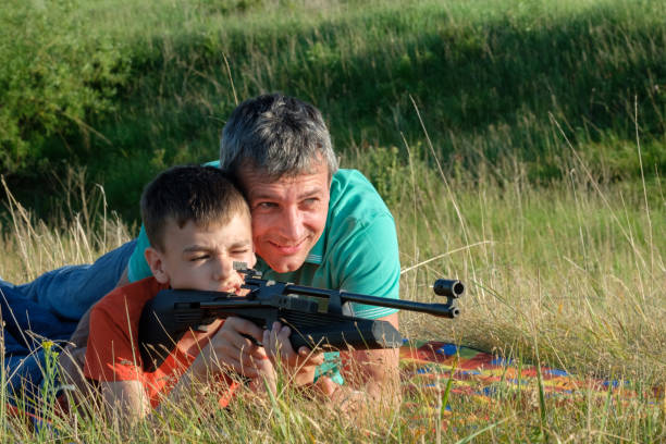 ojciec i syn rifle lekcje - air rifle zdjęcia i obrazy z banku zdjęć