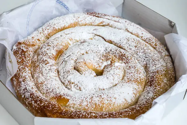 Mallorcan Ensaimada, Spanish dessert, baked with flour, water, sugar, eggs, sourdough and lard to which you can add cream, angel hair