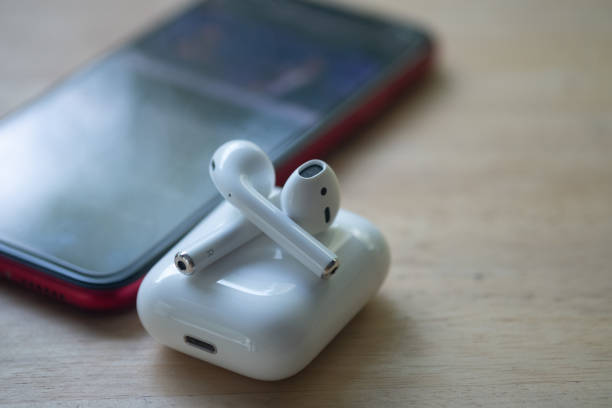Samut Prakan, Thailand - June 21, 2020 : Apple AirPods wireless headphone with charging box. Use with Iphone, Ipad or Mac. Samut Prakan, Thailand - June 21, 2020 : Apple AirPods wireless headphone with charging box. Use with Iphone, Ipad or Mac. charging sports photos stock pictures, royalty-free photos & images