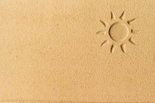 Sun hand-drawn on sand tropical beach. Beach holiday concept. Creative, background, copy space, travel, summer. Flat lay