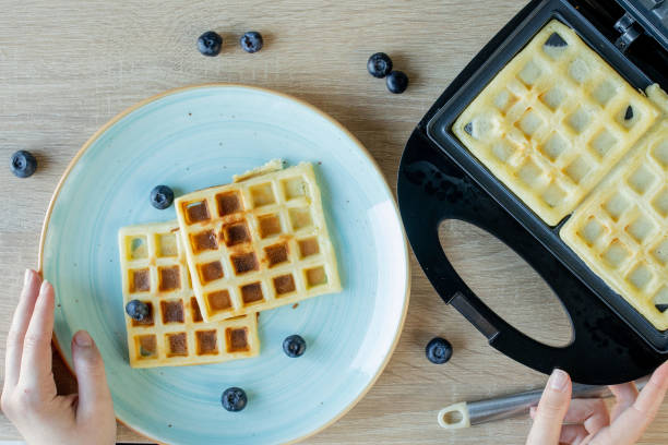 istock Waffles Being Baked in the Waffle Maker. Savory waffles. Breakfast concept 1251158764