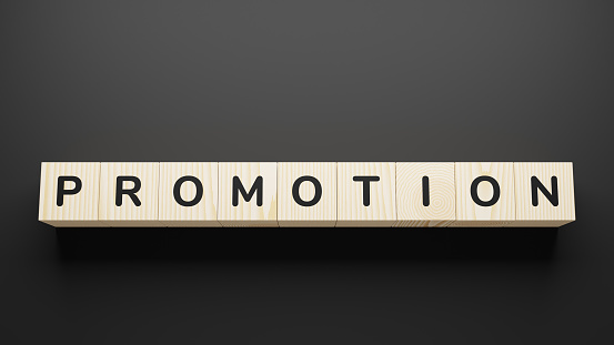 PROMOTION word on wooden blocks on gray background.