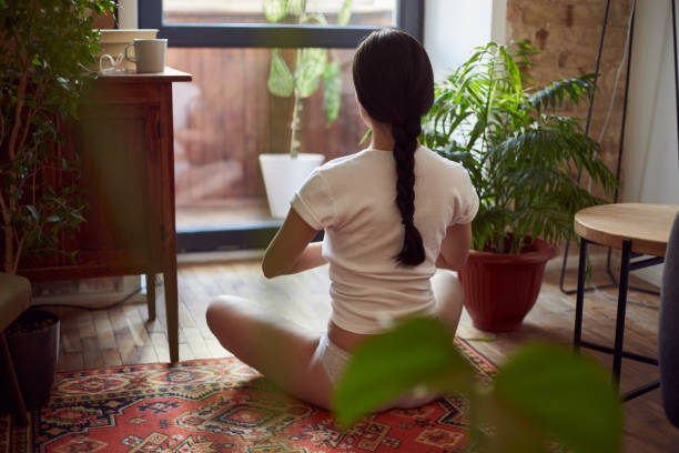 istock Calm female sitting on floor in a meditative pose 1251161075