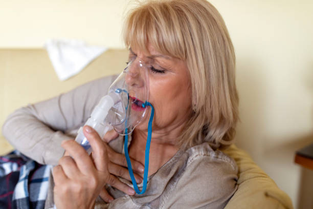 istock Sick Older Woman in the Bed with Asthmatic Problems. 1251161262