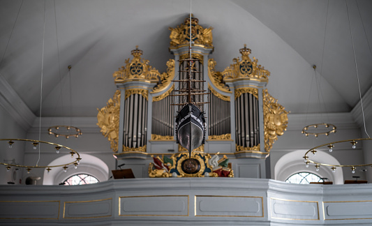 Votive ship and pipe organ in Kastelskirken - Citadel church - from the 18th century in the Citadel, Copenhagen, Denmark.