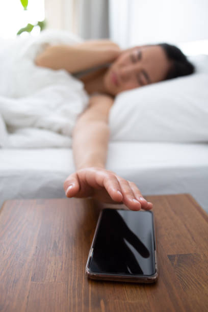 istock Female waking up by noise from smartphone 1251164444
