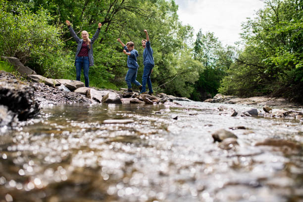 istock Kids hikers enjoying time by the river 1251164458