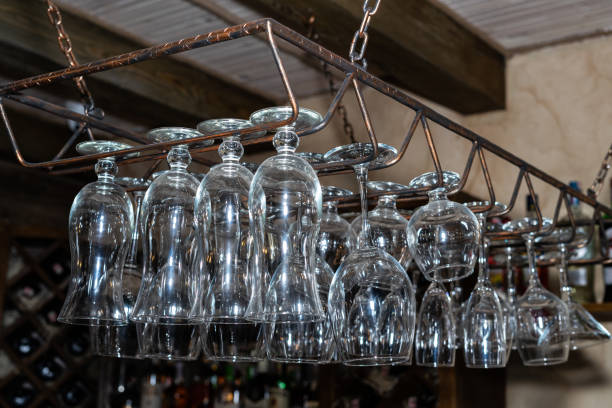 istock Many glass goblets hang over the bar. Empty glasses 1251165957