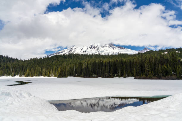 istock Reflection Lake Thawing Out With Ice and Snow Looking Towards Mount Rainier 1251167026