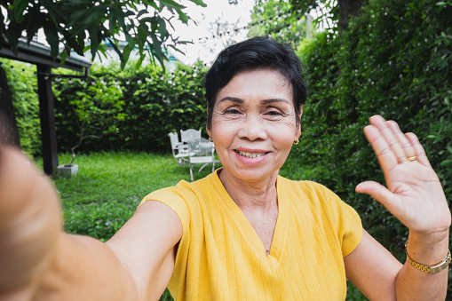 Asian senior woman selfie while video call with family