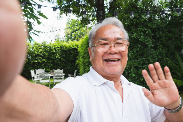 istock Asian senior man selfie while video call with family 1251168174