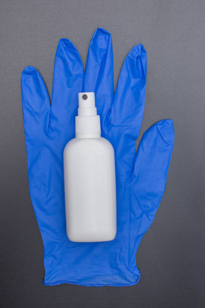 istock protection glove and alcohol sanitizer on dark surface 1251168311