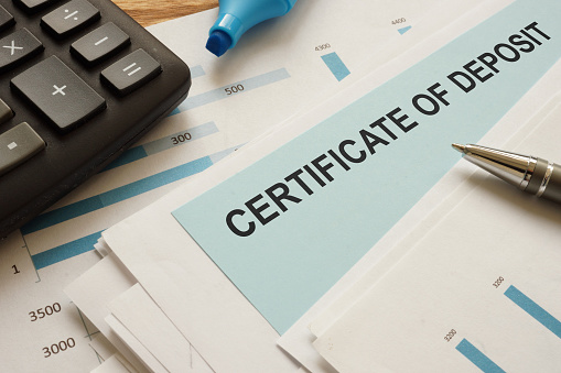 certificate of deposit CD is shown on a conceptual business photo