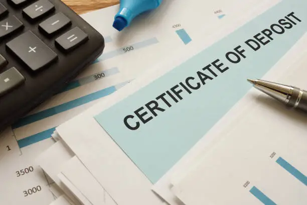Photo of certificate of deposit CD is shown on the conceptual business photo