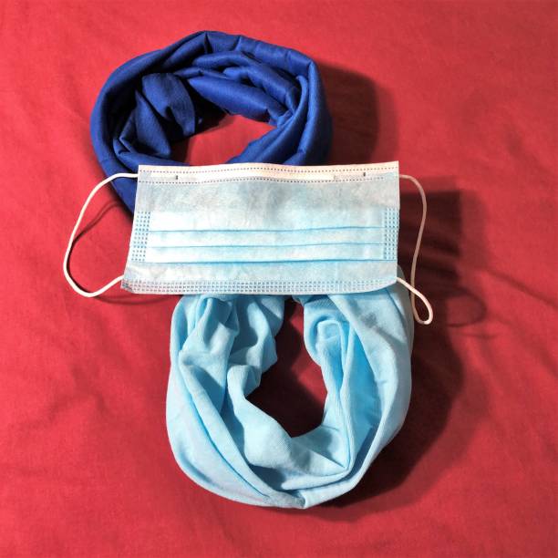 istock Disposable face mask lying across two bandana cloth face masks 1251168450