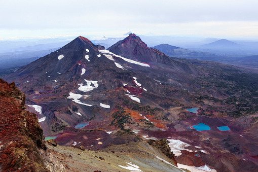 Snow patches and alpine lake visible under the mountain