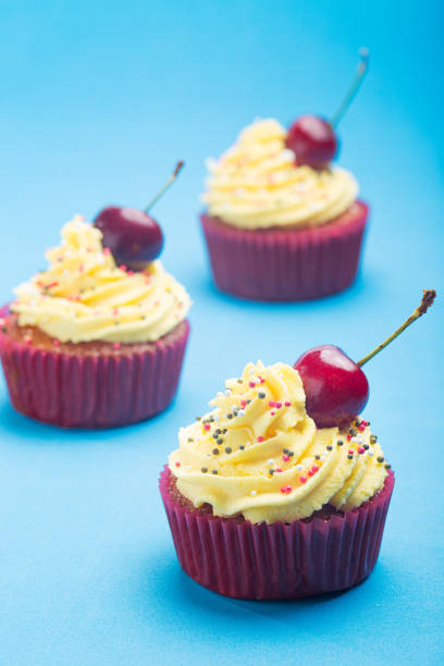 istock Cupcakes with whipped cream decorated with a cherry made without lactose 1251177350