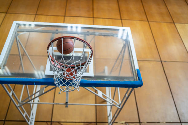 istock Ball falling in a Basketball Hoop 1251178441
