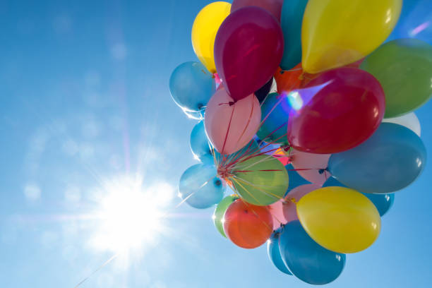 istock Colorful balloons with sky and sun in background 1251178548