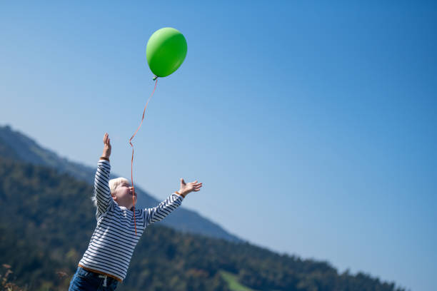 Girl with colorful balloons in the park