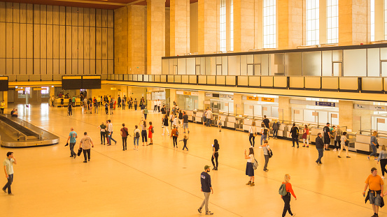 The massive former airport is shot on an open day with visitors in the main concourse