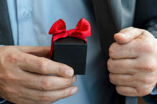 istock Businessman giving Gift Box 1251181471