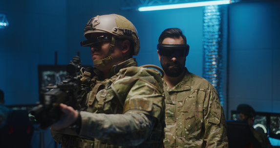 Medium shot of a soldier using VR gloves
