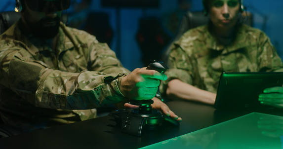 Medium shot of a soldier using remote controlling device