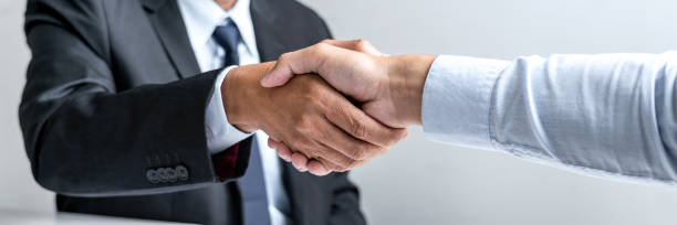 istock Greeting new colleagues, Handshake while job interviewing, male candidate shaking hands with Interviewer or employer after a job interview, employment and recruitment concept 1251183020