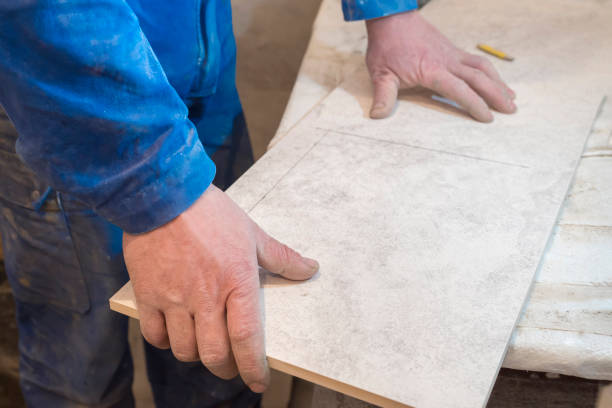istock Builder bricklayer installs ceramic tiles. Apartment renovation. 1251184048