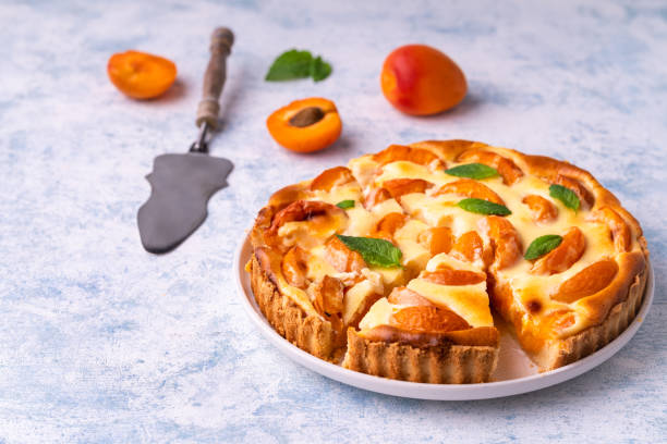 istock Apricot mascarpone tart, on blue background. 1251184242