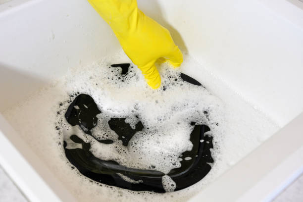 istock Washing dishes in the sink. Homework in the kitchen. 1251184981
